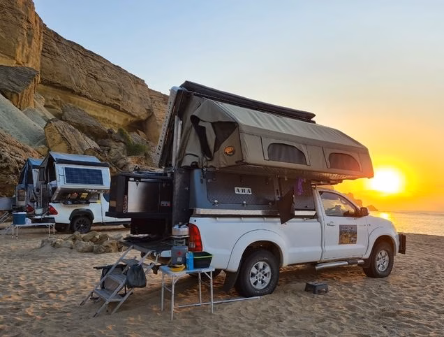 AHA Transformer setup at a beach camp during sunset.