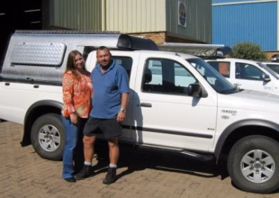Andrê and Doris Diedericks with their AHA-45 on a Mitsubishi Colt Double Cab, collected at the AHA Outdoor Systems factory.