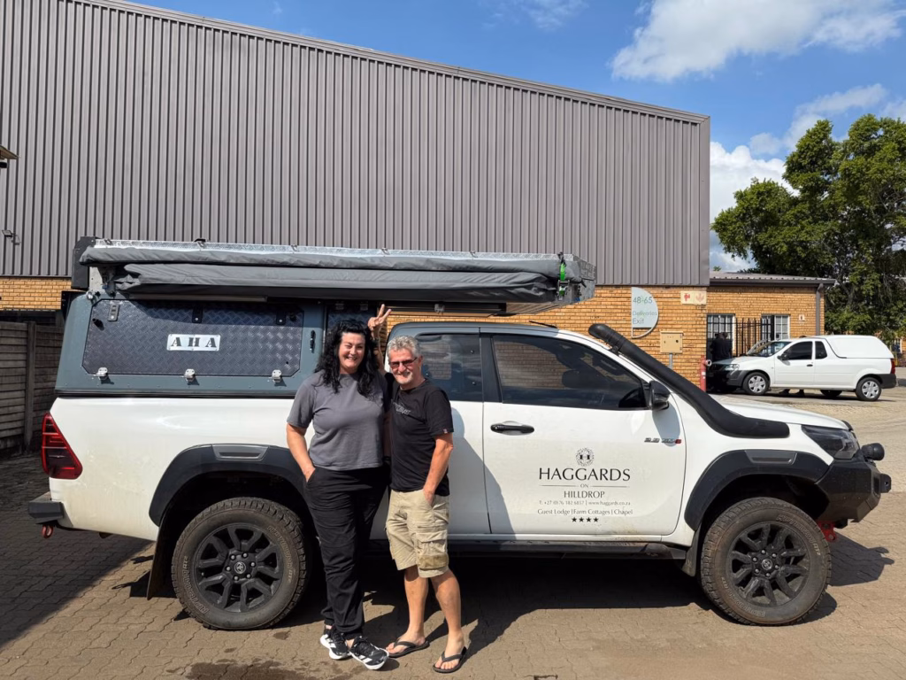 André & Lelanie Joubert | Toyota Hilux Extra Cab | Newcastle, KwaZulu-Natal André & Lelanie Joubert with their AHA Transformer on a Toyota Hilux Extra Cab, collected at the AHA Outdoor Systems factory, 2025.