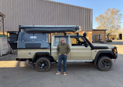 Anton and Michelle Barnard with their AHA Transformer on a Toyota Land Cruiser Double Cab, collected at the AHA Outdoor Systems factory, 2025.