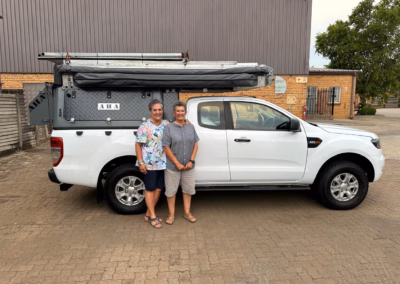 Daleen and Esme Broekman with their AHA Transformer on a Ford Ranger Extra Cab, collected at the AHA Outdoor Systems factory, 2025.