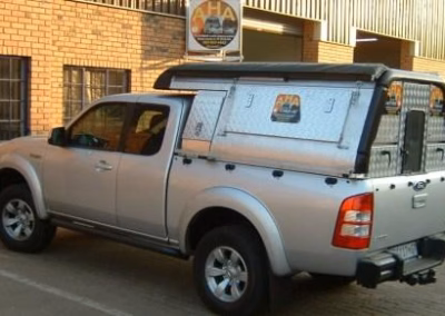 Dawie and Annetjie Meyer with their AHA-45 on a Proton Arena Single Cab, collected at the AHA Outdoor Systems factory.