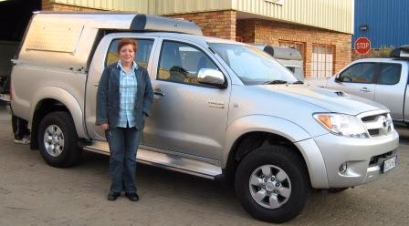Dennis and Cecilia Robinson with their AHA-45 on a Toyota Hilux Double Cab, collected at the AHA Outdoor Systems factory.