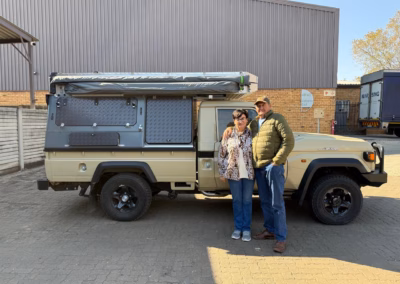 Deon and Marelize Van Zyl with their AHA Transformer on a Toyota Land Cruiser Double Cab, collected at the AHA Outdoor Systems factory, 2025.