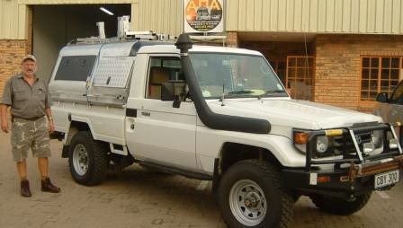 Henri and Amanda Bredenkamp with their AHA-45 on a Toyota Land Cruiser Single Cab, collected at the AHA Outdoor Systems factory.