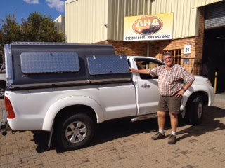 Johan Van Der Merwe with their AHA-45 on a Toyota Single Cab, collected at the AHA Outdoor Systems factory, 2012.