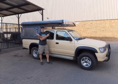 Mike Cave with their AHA Transformer on a Toyota Hilux Double Cab, collected at the AHA Outdoor Systems factory, 2020.
