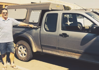 Percy Reynolds with their AHA-45 on a Isuzu Extra Cab, collected at the AHA Outdoor Systems factory, 2014.
