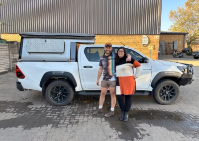 Stephan and Natasha Van Staden with their AHA Transformer on a Toyota Hilux Double Cab, collected at the AHA Outdoor Systems factory, 2024.