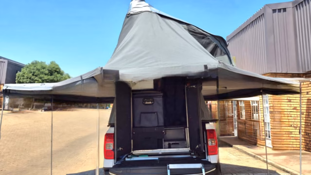 The raincoat and both awnings (left awning and right awning) of a pre-owned 2024 AHA Transformer set up at the AHA factory.
