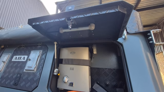Outside left hand geyser and gas compartment on a 2024 AHA Transformer.