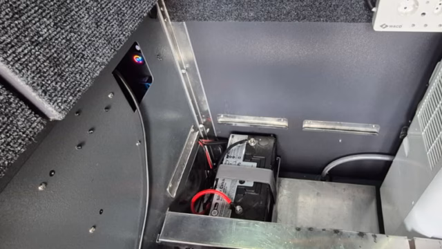 Battery and storage area under the bed of a pre-owned 2023 AHA Transformer.