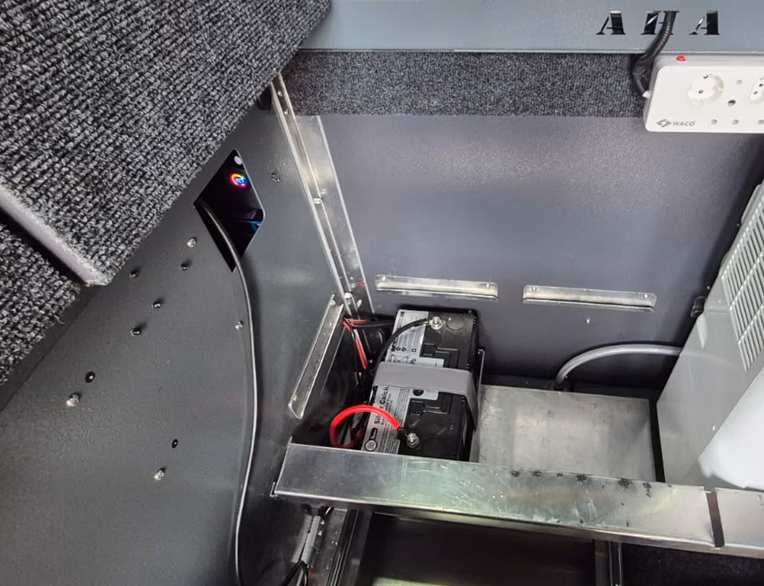 Battery and storage area under the bed of a pre-owned 2023 AHA Transformer.