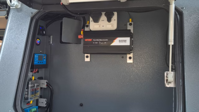 Left hand electrical compartment and storage area of a pre-owned 2023 AHA Transformer.