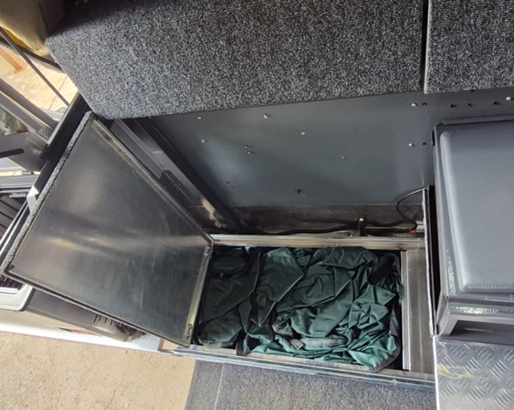 Inside shower of a pre-owned 2023 AHA Transformer, folded away.