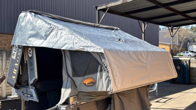 Safety raincoat with silver coating fitted over the right hand side of the unit.
