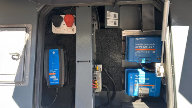 Electrical compartment box open, showing the Victron components mounted inside.