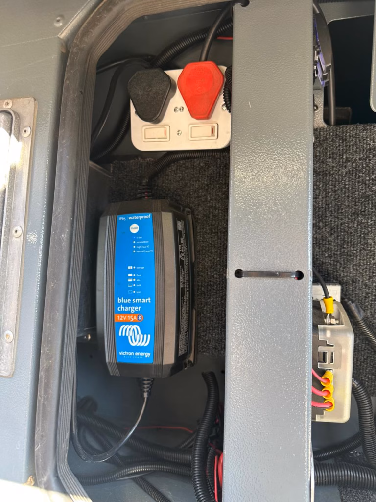 Victron Blue Smart IP65 12/15 amp charger fitted in the electrical panel.