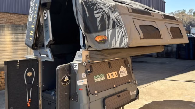 A 2025 AHA Transformer standing fully open with both awnings out.