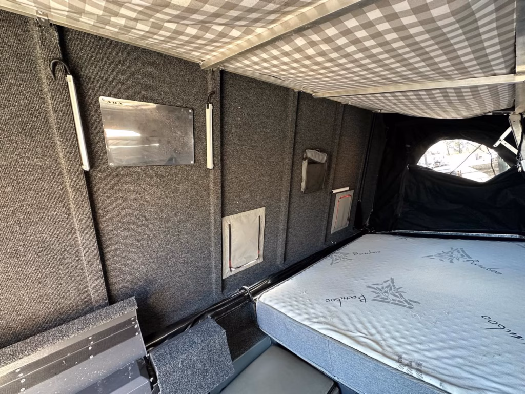 Bed area inside the Transformer with the interior lights switched on.