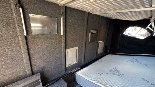 Bed area inside the Transformer with the interior lights switched on.